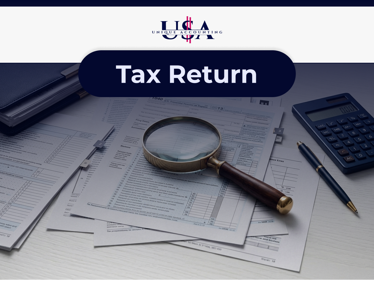 Magnifying glass over tax documents representing accurate tax return preparation